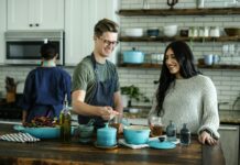 건강한 식습관, 가정에서부터 실천하기 smiling man standing and mixing near woman in kitchen area of the house