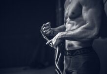 근육, 이젠 건강의 척도…‘근육 건강’ 챙기는 라이프스타일이 뜬다 a shirtless man holding a pair of gloves