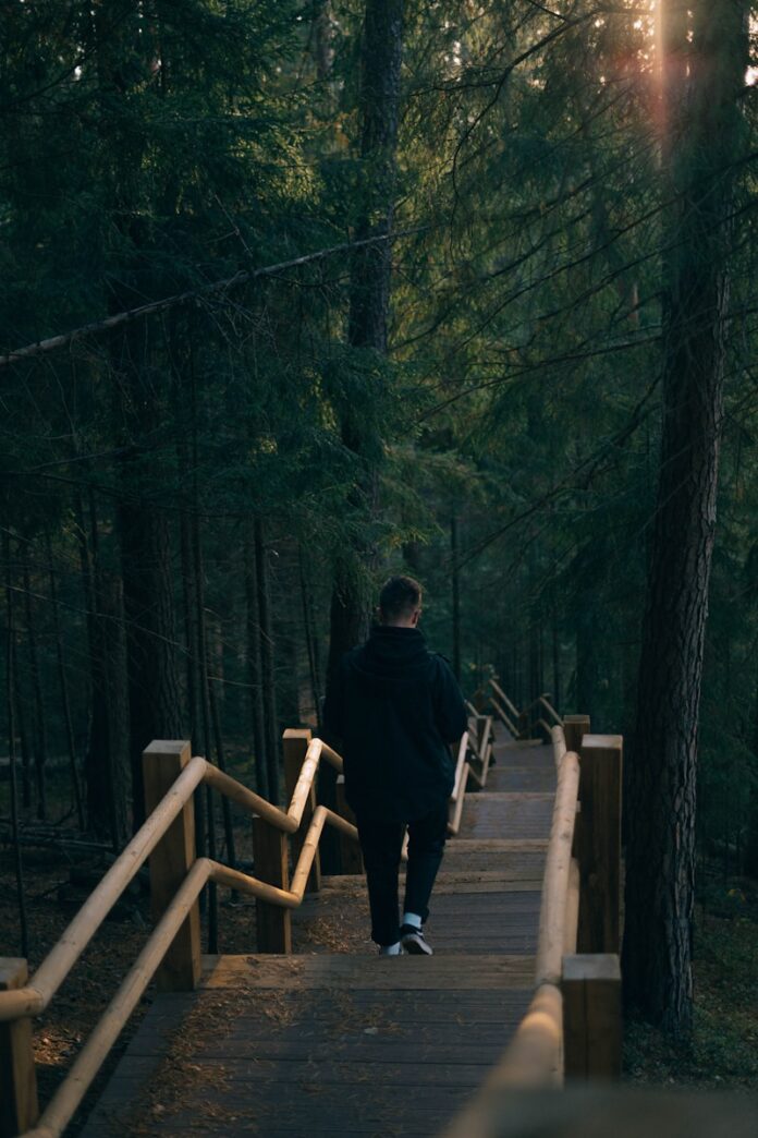 man walking near trees