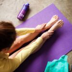 “근육이 건강을 지킨다”…일상 속 실천 가능한 근육 관리 트렌드와 꿀팁 woman in yellow pants lying on purple textile