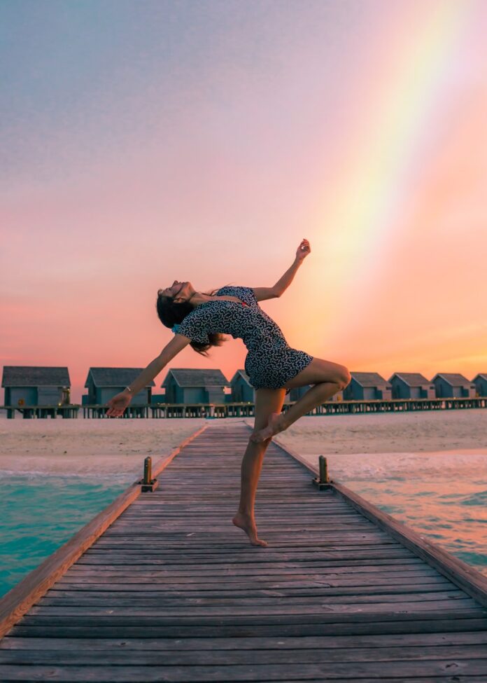 Photo by Drew Colins woman standing on dock