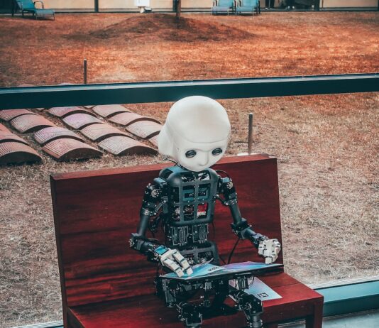 “AI와 함께하는 스마트 건강 관리…일상 속 실천법 제안” black and white robot toy on red wooden table