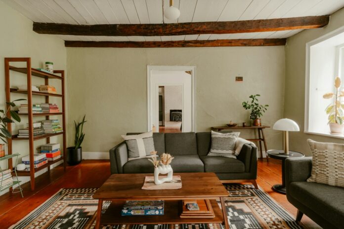 Photo by Clay Banks Living room with sofa, coffee table, and exposed beams