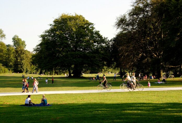 Photo by Ignacio Brosa people relaxing and biking in sunny park