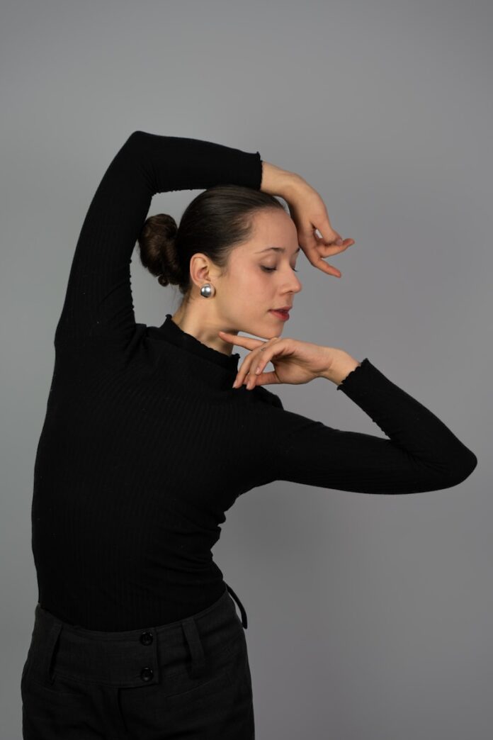 Photo by Kajetan Sumila a woman in a black top is posing for a picture